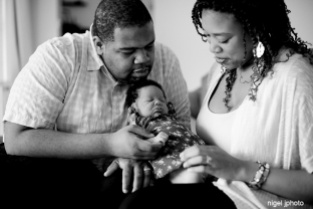 newborn-girl-held-by-new-parents-african-american-seattle-family-photography
